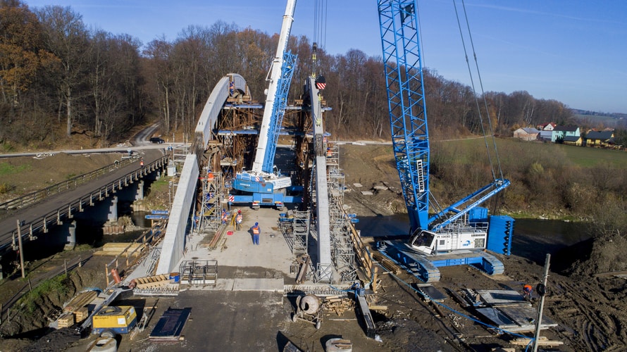 Żurawie gąsienicowy LR 1300 i samojezdny LTM 1160-5.1 budują most nad rzeką Białą w Jankowej-Lipniczce